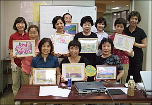写真:完成したぬり絵と一緒に記念撮影する参加者たち