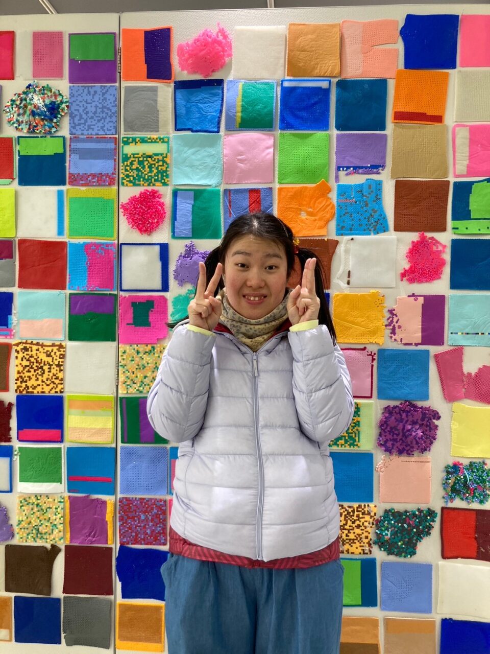 画像：展覧会「about me６」の会場に展示された作品の前で記念撮影するつちたにさん